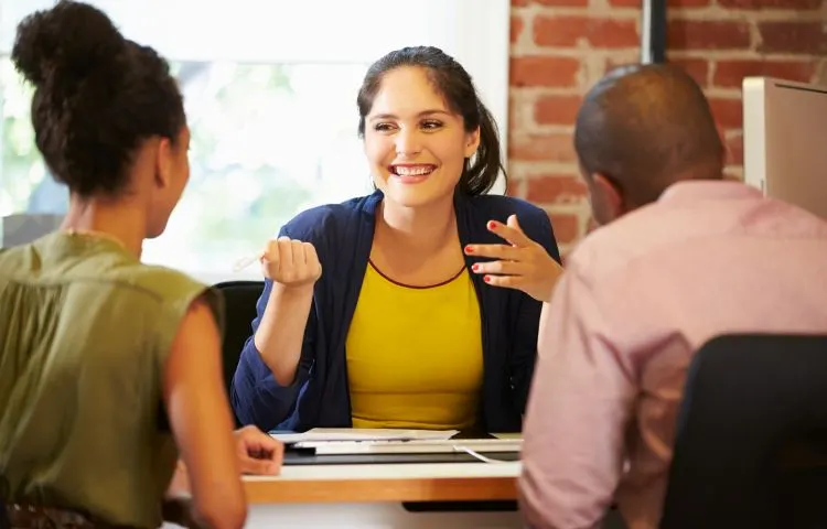 A financial advisor explaining a plan to a smiling family.