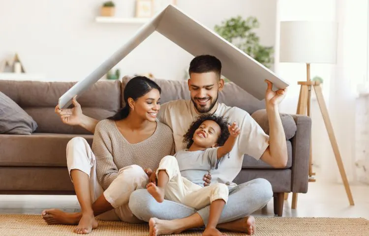 cardboard forming a roof over a family